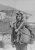 Linton Jones in flying gear in front of a Tiger Moth Bi-Plane. 